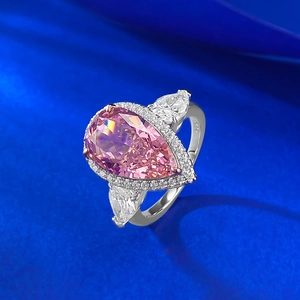 Macro detail of a 925 silver ring featuring a pear-cut pink gemstone and side stones
