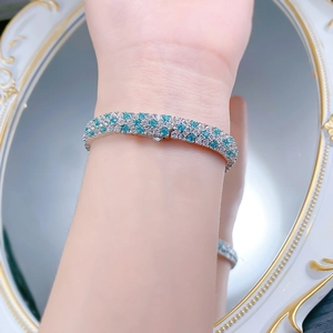 Detailed view of S925 silver bracelet with inlaid turquoise gems and sparkling diamonds