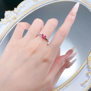 Close-up of 925 silver ring featuring three pink heart-shaped stones in a cluster