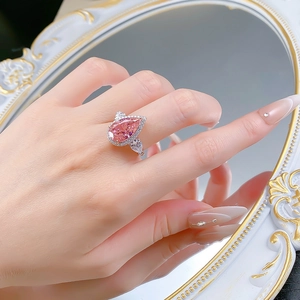 Detailed view of luxury pear cut pink gemstone ring in silver set with accent diamonds