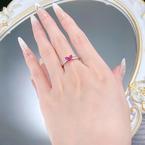 Macro detail of a 925 silver heart ring with ruby gemstone on a model's hand