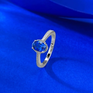 Elegant S925 sterling silver ring with oval blue sapphire and pavé diamond accents
