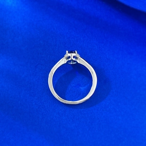 Macro view of 5x7mm oval blue sapphire ring with S925 silver four-prong setting