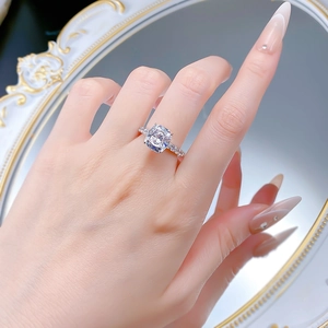 Detail of S925 silver cushion cut ring with sparkling accents worn on hand