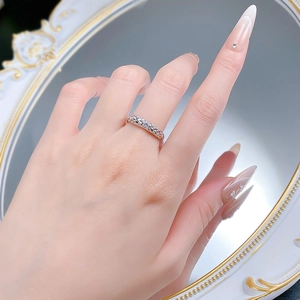 Detailed view of a vintage silver ring with dragon scale texture and a moissanite stone