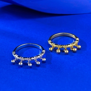Minimalist S925 silver and gold tassel rings with small metal beads on blue surface