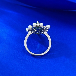 Macro shot of 925 silver ring with 7x13mm green water drop stone and pearls