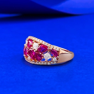 Luxurious rose gold cluster ring featuring red gems and sparkling cubic zirconia stones