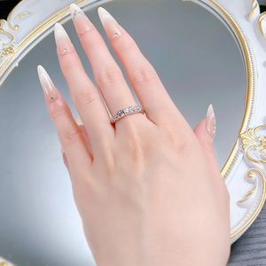 Detail of 925 silver dragon scale ring with moissanite stone on model's hand