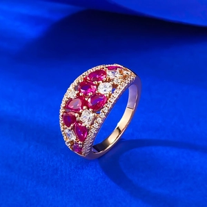 Luxurious rose gold ring featuring pear-cut red zircons and sparkling white diamond accents