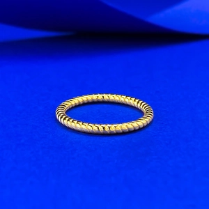Macro shot of 925 silver golden twisted rope ring on a premium blue background