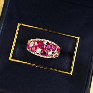 Luxurious gold ring featuring pear-cut red zircons and micro-pave white crystals