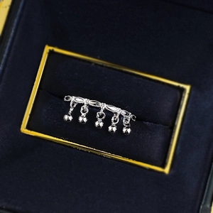 Detail of S925 sterling silver ring featuring five dangling bell tassels in a velvet box