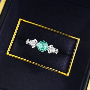 Detail shot of the 6mm round Paraiba blue stone in a S925 silver ring on velvet