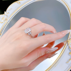 Macro view of S925 silver ring with large emerald cut diamond and side stones