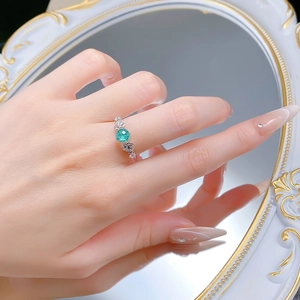 Detailed view of S925 silver ring featuring round mint green gem and carved roses