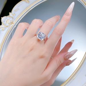 Close-up of Asscher cut square diamond ring with micro-pave band on a finger