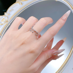 Detailed view of an S925 silver ring featuring five delicate bell tassel pendants on finger