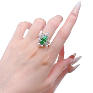 925 silver ring featuring a 7x13mm pear-cut green stone and pearl accents on model hand