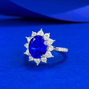 Elegant S925 silver ring featuring an oval blue gemstone with floral diamond halo