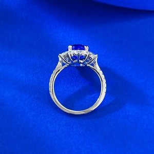S925 silver ring featuring an oval blue gemstone surrounded by white crystals