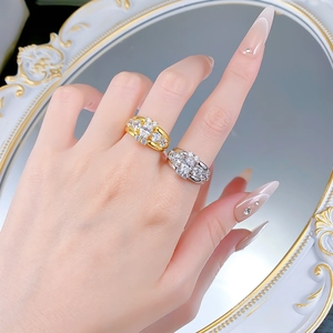 Detailed view of luxury oval solitaire rings in gold and silver finish worn on fingers
