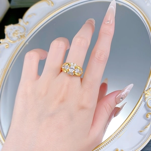 Close-up of luxury 925 silver gold-plated ring with oval clear gemstone worn on finger