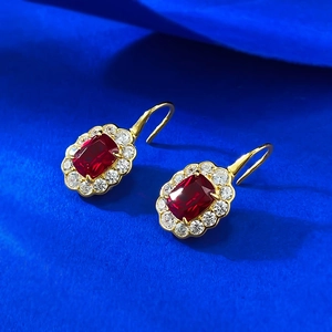 Elegant 925 silver red ruby halo stud earrings with gold plating on blue background
