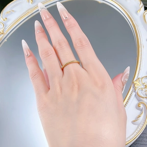Close-up of a twisted gold 925 silver ring worn on a finger against a mirror backdrop