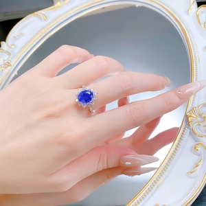 Detail of s925 silver ring featuring an oval blue flower sapphire and white zircons