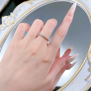 Detailed view of a slender S925 sterling silver twisted rope ring worn on a finger