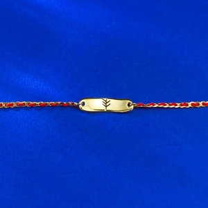 Minimalist red and gold woven zodiac bracelet with polished gold-plated plaque on blue fabric