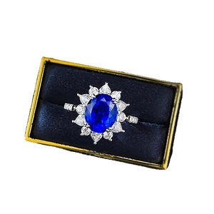 Elegant 925 silver ring with oval blue sapphire and white diamond halo in a gift box