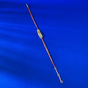 Detailed view of S925 silver red string bracelet with gold BABY engraved oval plate
