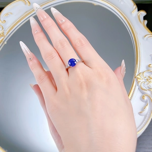 Close-up of elegant S925 silver ring with 8mm blue spinel and side diamond accents