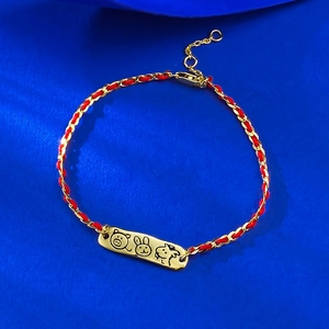 Zodiac red cord bracelet with gold charms featuring cartoon pig, rabbit and dog engravings
