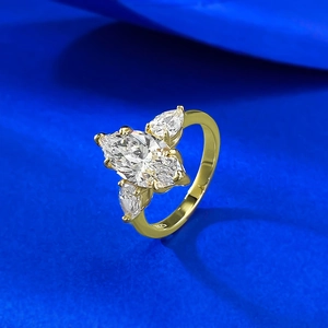 Macro detail of gold-plated S925 silver ring featuring marquise-cut stone on blue background