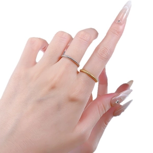 Minimalist twisted rope rings in gold and silver finish shown on a hand for stacking