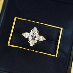 Macro shot of 925 silver gold marquise cut ring in a luxury blue velvet jewelry box