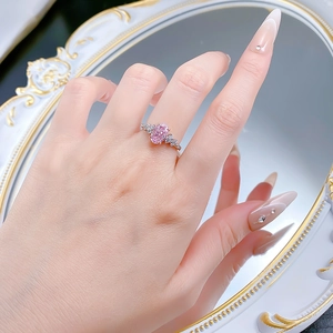 Detail of S925 silver ring featuring an oval pink gemstone with marquise side stones