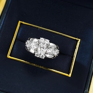 Macro view of oval-cut solitaire ring with halo diamond setting in velvet box