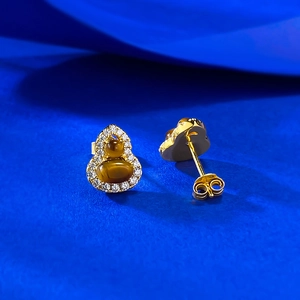 Elegant gold tiger eye gourd stud earrings with crystal halo on blue background