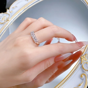 Detail of S925 silver ring featuring five emerald cut moissanite stones in prong setting