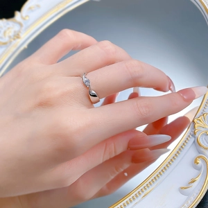 Detail of S925 sterling silver twist ring with a round zircon on a model's hand