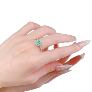 Classic S925 silver ring with emerald-cut green gemstone and halo flower design