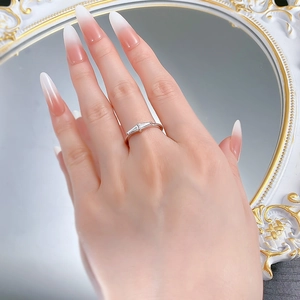 Detailed view of triple baguette-cut stones in a minimalist silver band on a hand