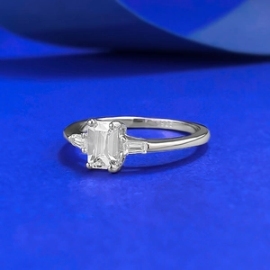 Minimalist S925 silver ring featuring emerald cut center stone and baguette side diamonds