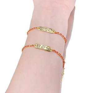 S925 silver red string bracelet with gold zodiac animal charm on a model's wrist