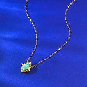 Vintage S925 silver necklace with oval opal pendant and gold finish on blue background