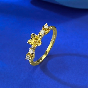 Elegant S925 gold-plated plum blossom ring with cubic zirconia on a navy surface